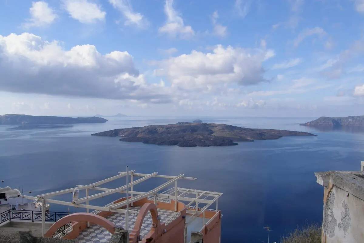 View over the Santorini caldera toward the Nea Kameni volcanic island from Fira