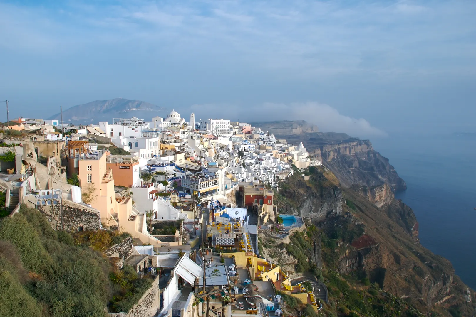 Whitewashed buildings of Fira stacked along the caldera cliff edge