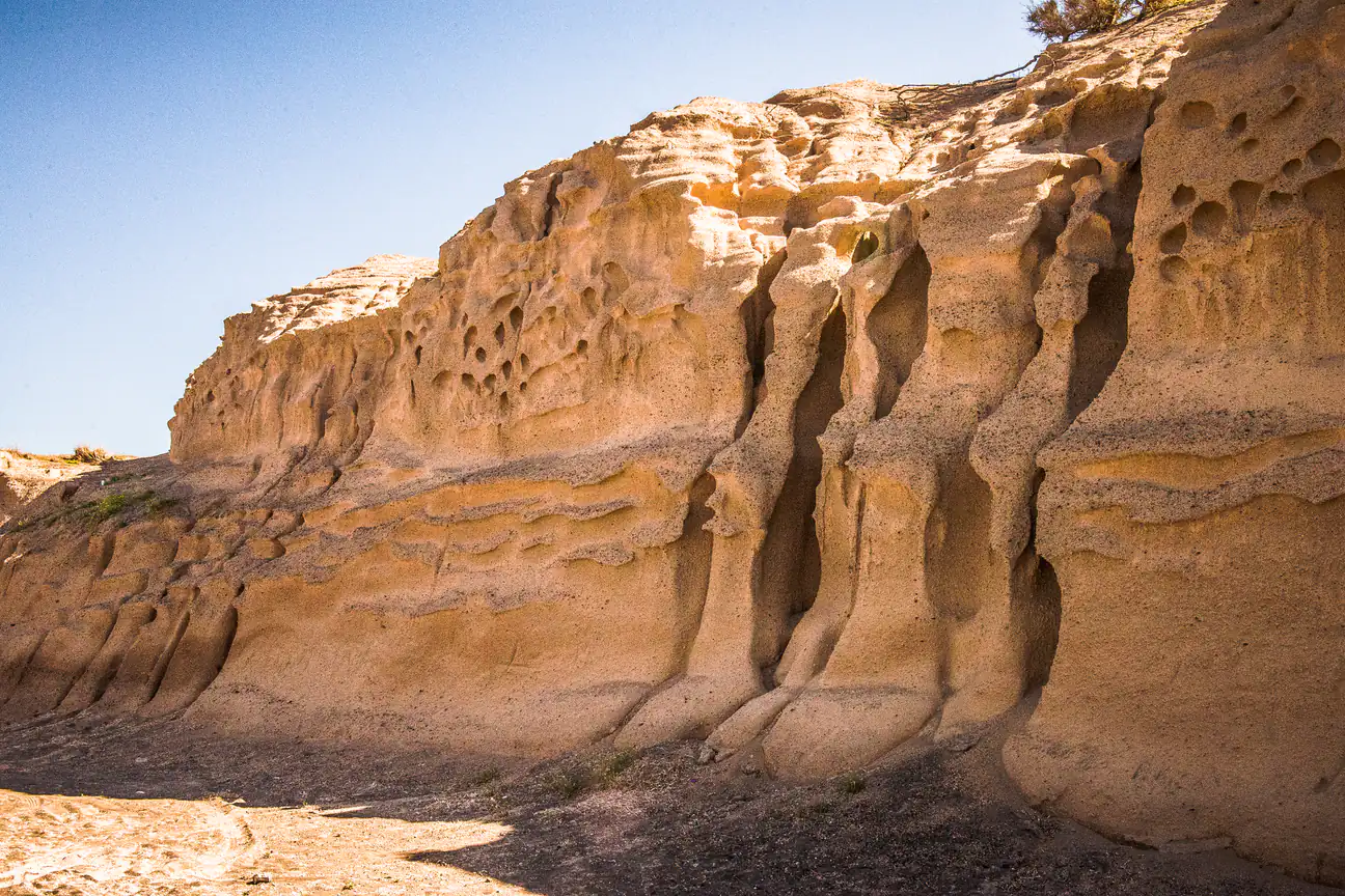 Wind-carved sandstone cliffs at Monolithos beach, Santorini