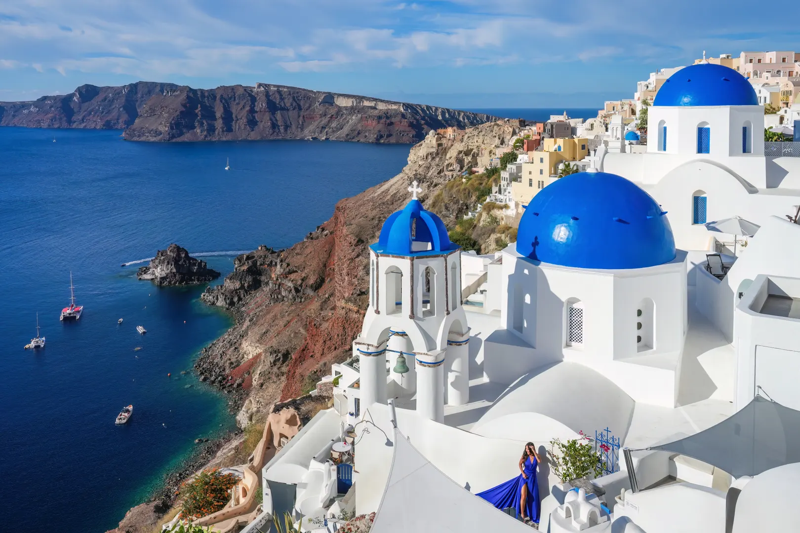 Three blue church domes above the caldera in Oia, Santorini