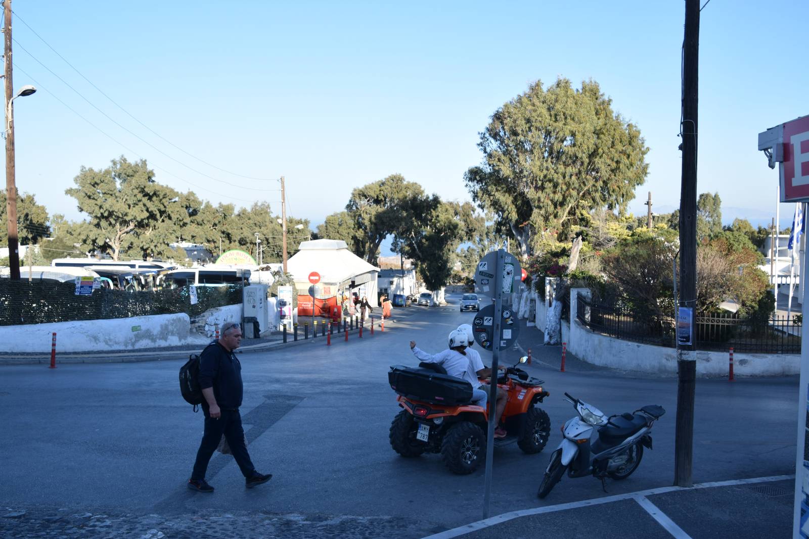 Street entrance to the central bus station in Fira with parked KTEL buses in the background